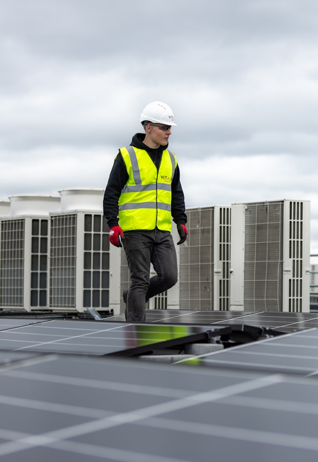 HVAC technician walking a rooftop between condenser units