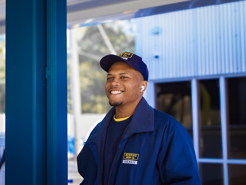 Smiling HVAC technician in uniform outside a job site